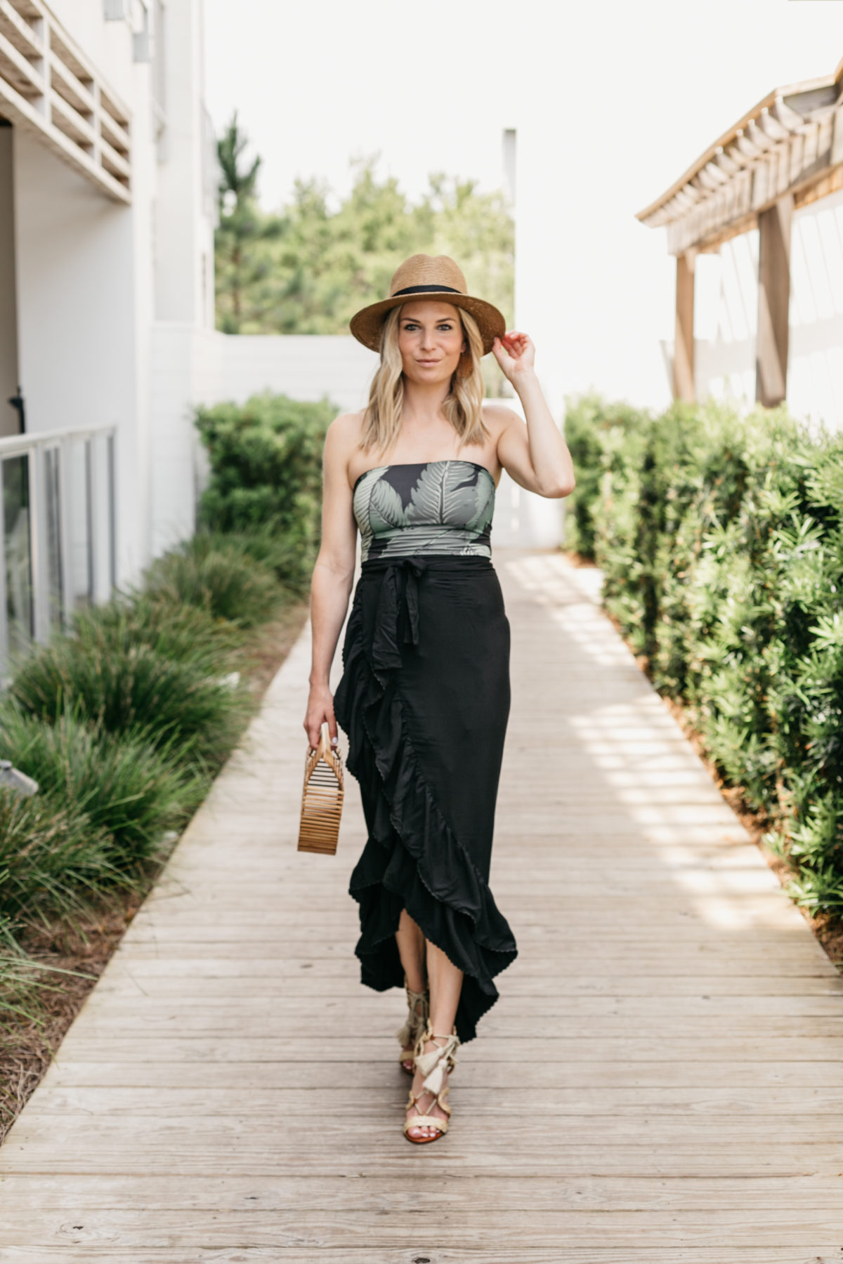 Broke Outfit Details: Palm Print Bodysuit/Swimsuit // Black Ruffle Midi Skirt // Strappy Heel // Straw Hat // Wooden Bag
