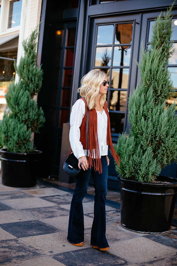 suede vest with fringe-peasant blouse-black saddle bag-high rise flare jeans-dallas fashion blogger