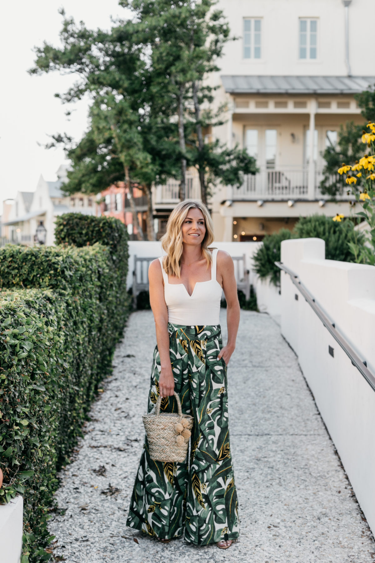 Brooke Burnett outfit details: Palm Print Pant // White V Neck Top // Sandals // Straw Bag