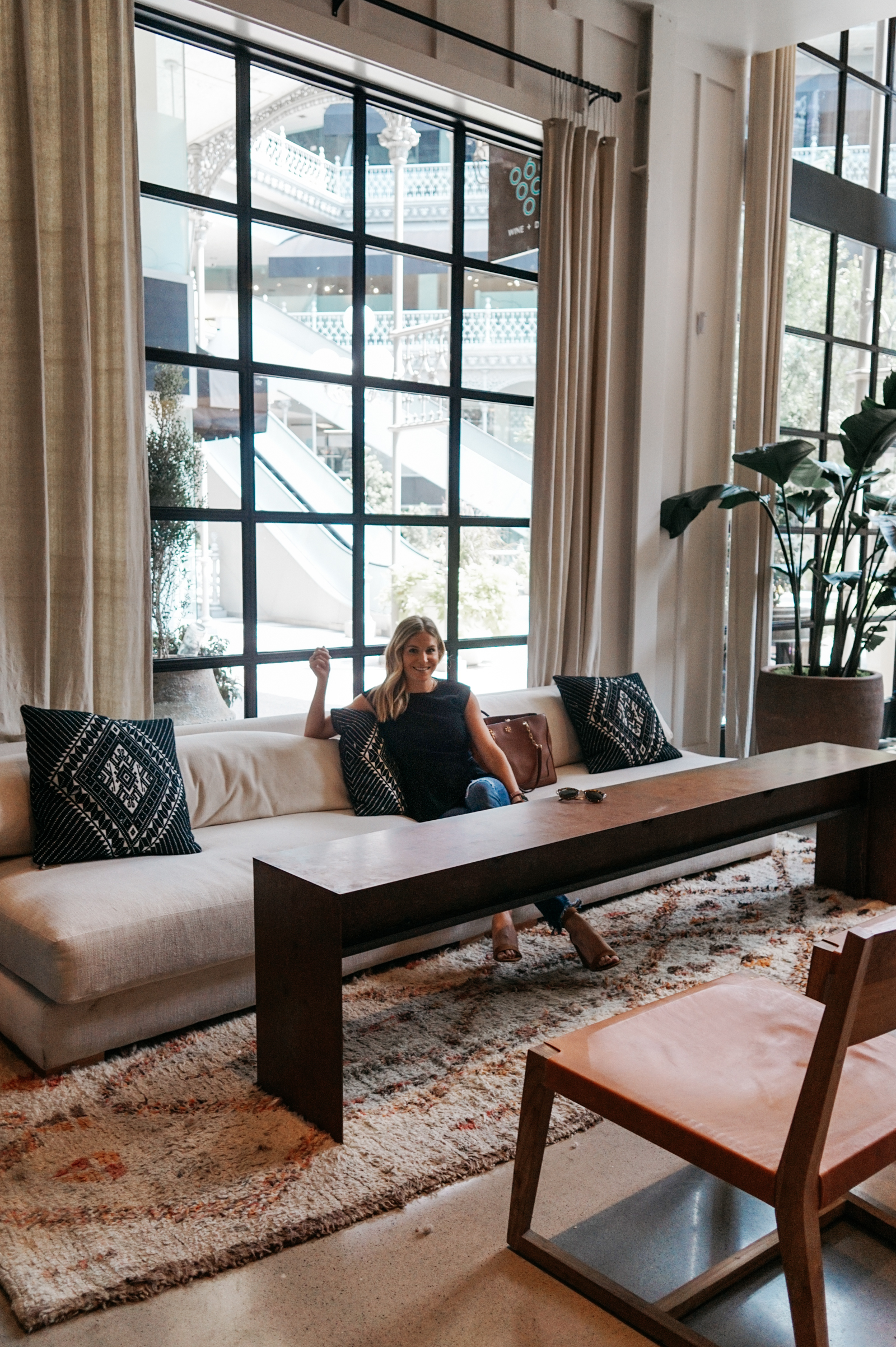 woman sitting on a couch dallas summer 2018