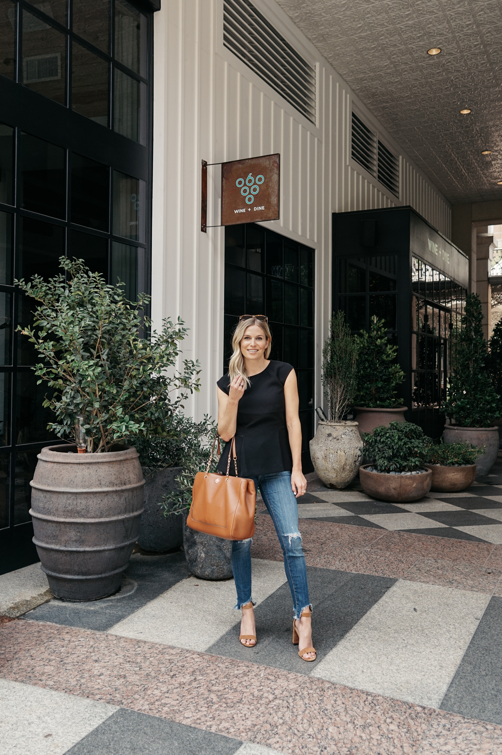 woman wearing black top and jeans for dallas summer 2018